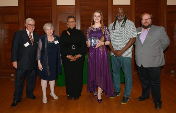 Six people holding awards