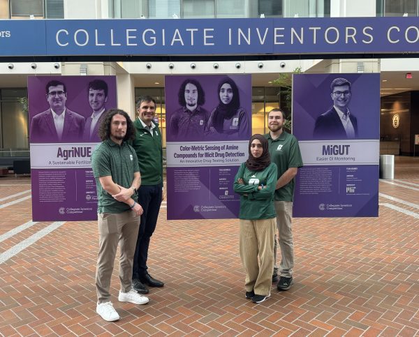 The student researchers and their advisors stand with the life size poster displaying their photos and the name of their invention.