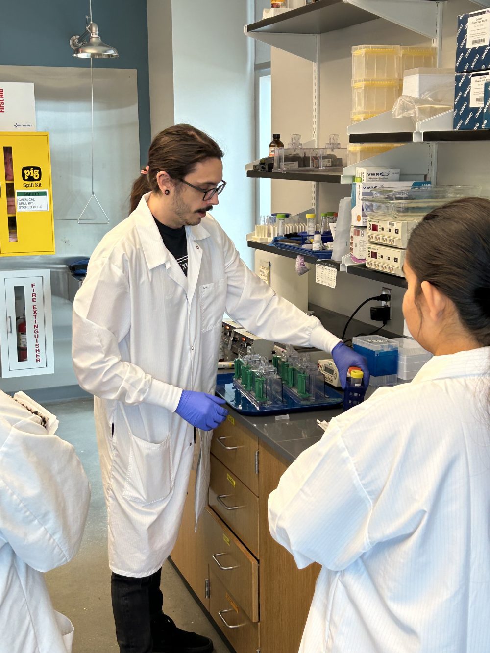 Alex Suptela works in the lab with students.