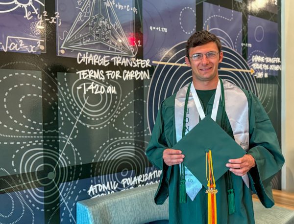 Ean Bass holds his graduation cap with three 2025 tassels.