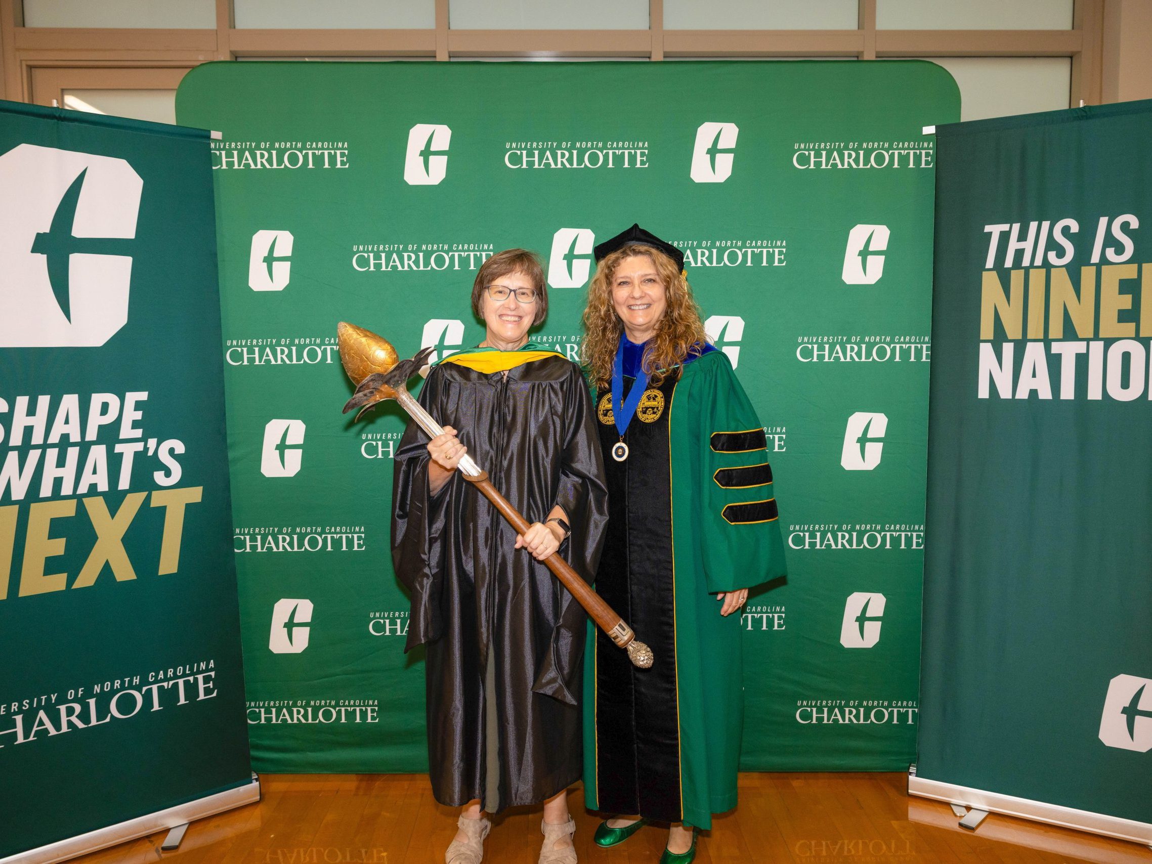 Michael poses with the mace with Klein College of Science Dean Bernadette Donovan-Merkert.