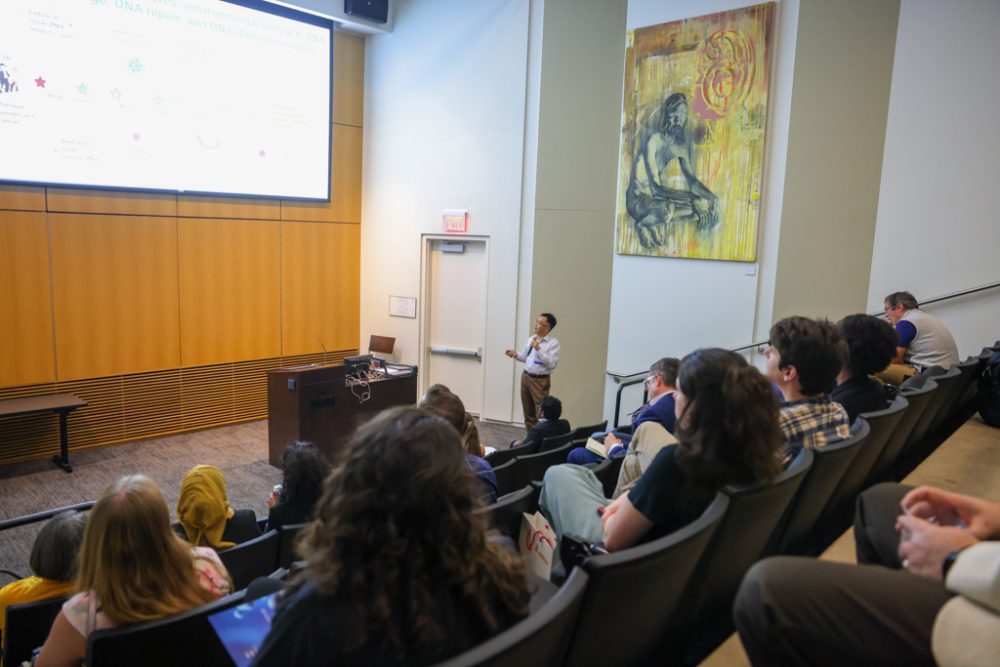 Shan Yan speaks to an auditorium.