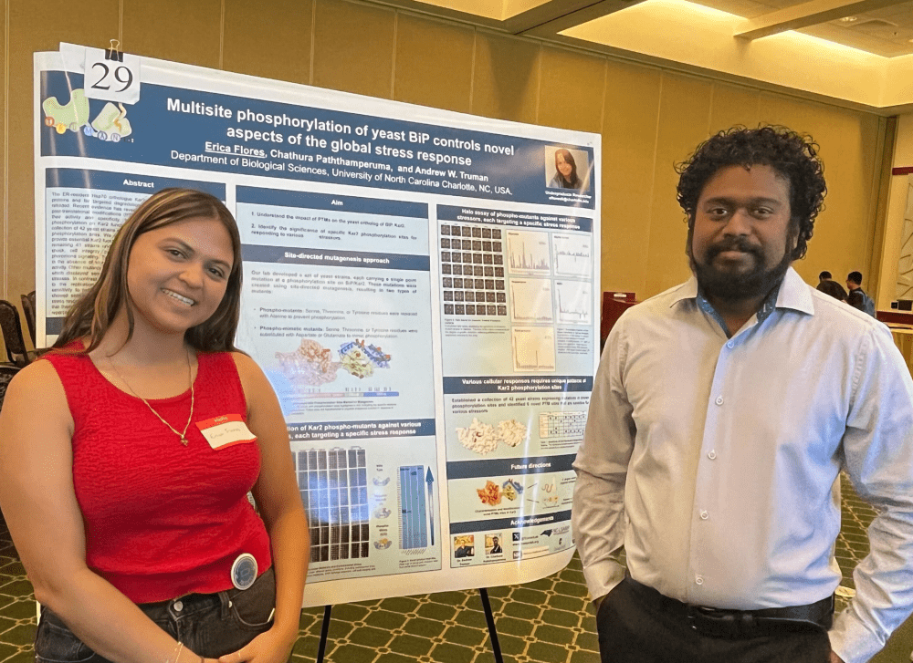 Flores and Chathura Pathamperuma with her research poster at the 2024 ABSGS Annual Biological Sciences Symposium