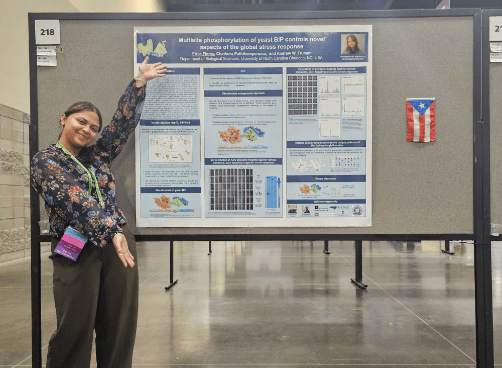 Erica Flores posing with her research poster at the 2024 SACNAS NDiSTEM Conference