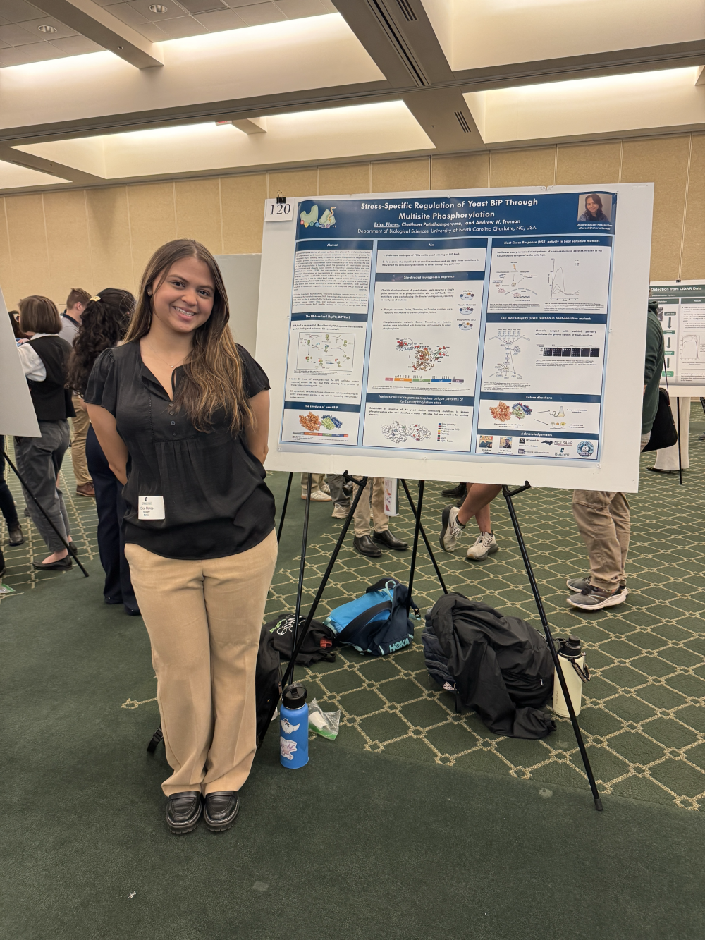 Flores posing with her poster at the 2025 Undergraduate Research Conference