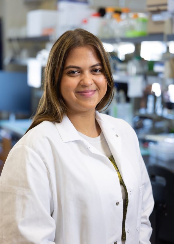 Erica Flores wears a lab coat in the Truman Lab.