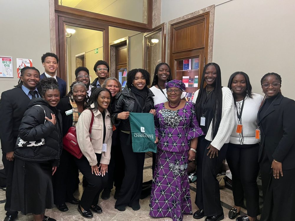Ntasin and a group of students posing in a building alongside Ngozi Okonjo-Iweala.