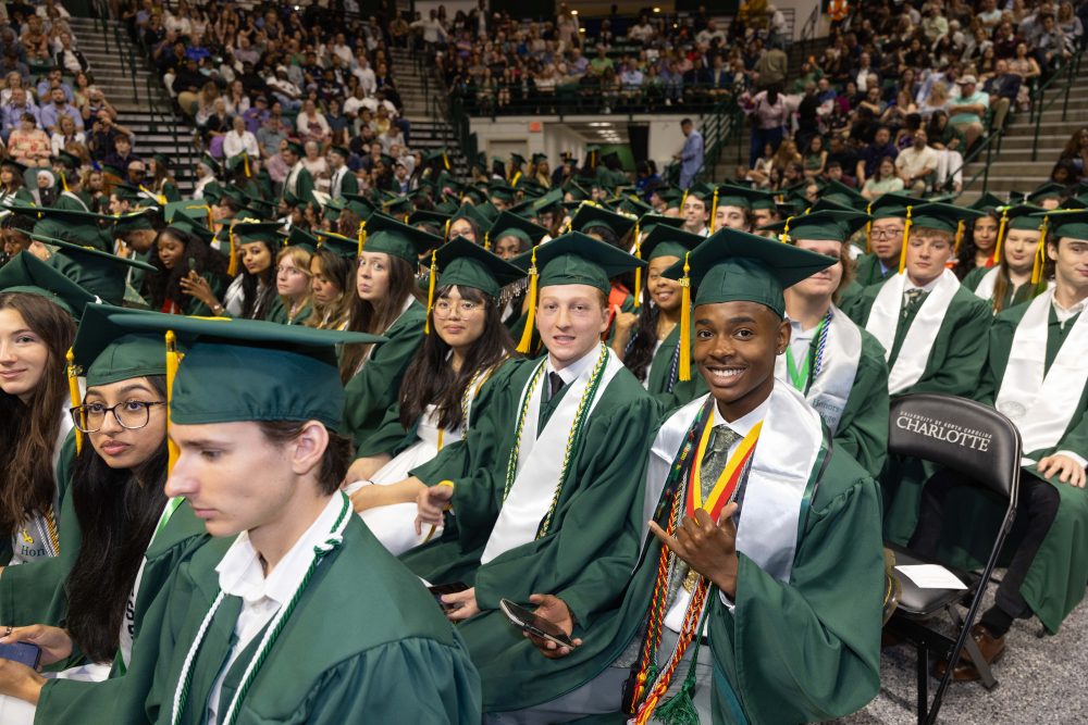Smiling UNC Charlotte graduates from the Klein College of Science.