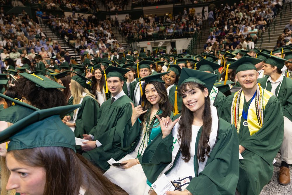 Smiling UNC Charlotte graduates from the Klein College of Science.