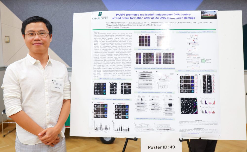 Zhao poses in front of his poster.