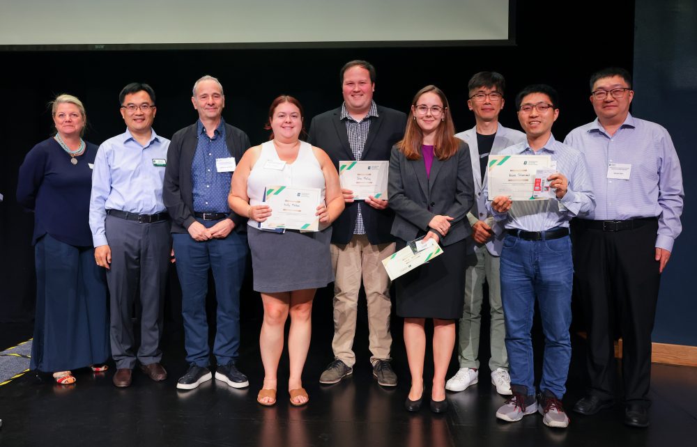 Poster winners pose for a group photo with the speakers and organizers.