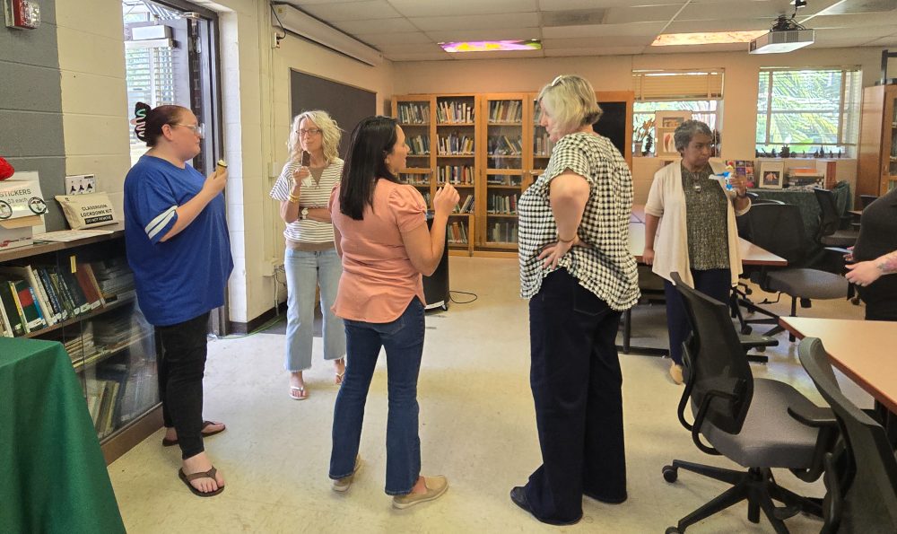 Staff from the UNC Charlotte Klein College of Science mingle in the Botanical Gardens classroom during the staff ice cream social event.