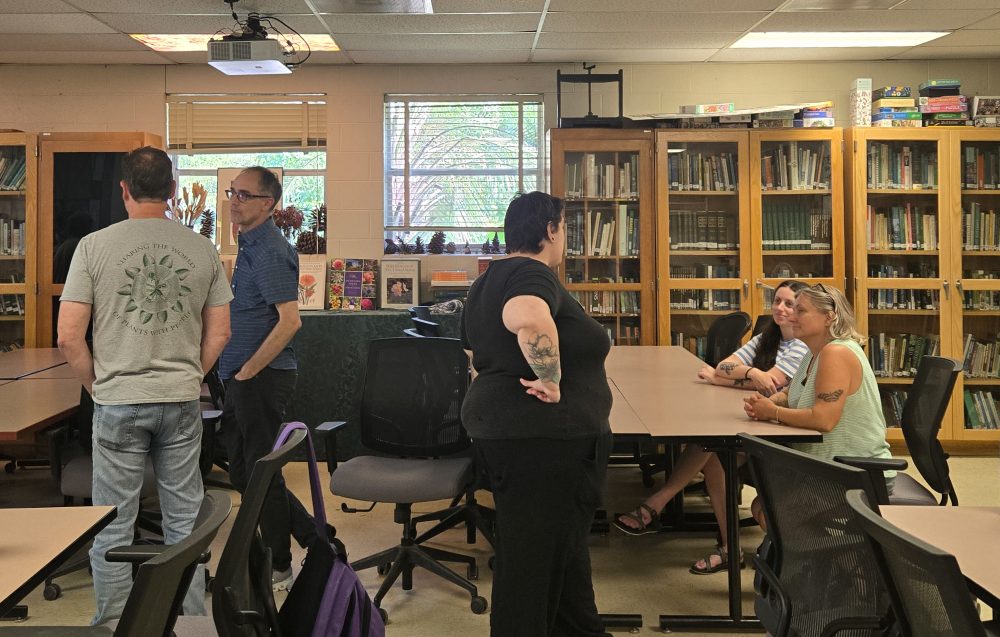 Staff from the UNC Charlotte Klein College of Science mingle in the Botanical Gardens classroom during the staff ice cream social event.