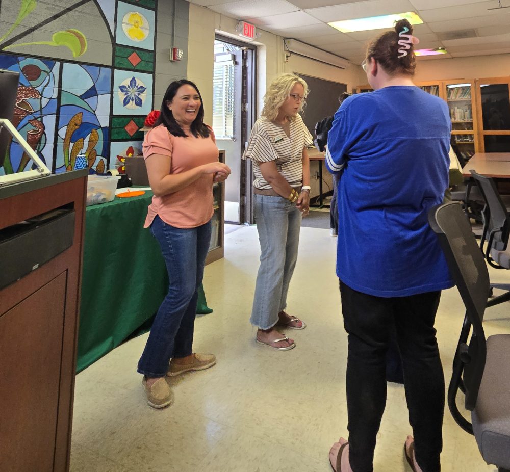 Staff from the UNC Charlotte Klein College of Science mingle in the Botanical Gardens classroom during the staff ice cream social event.