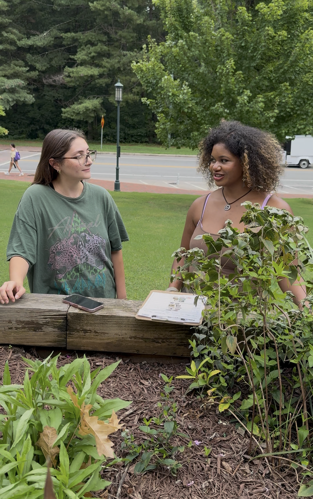 Zarah Rahman Blythe talks with another student at the Pollinator Garden by McEniry during the Great Southeastern Pollinator Census on Aug. 22, 2025.