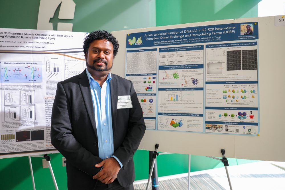 Chathura Paththamperum stands in front of his scientific research poster from the Truman Lab at the 2026 Biomedical Science Symposium.