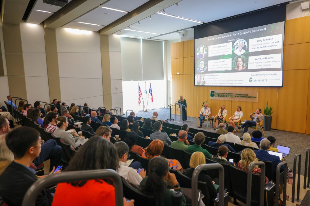 The full auditorium of attendees listens to the expert panel at the 2026 Biomedical Symposium help Spet. 14 at the UNC Charlotte Dubois Center.