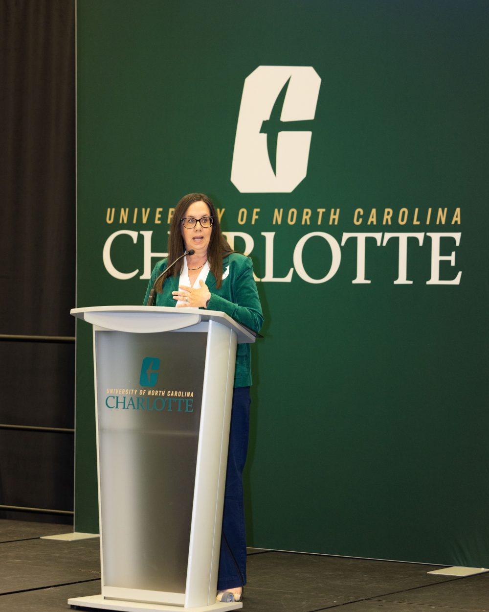 Tonya Bates in the Klein College of Science speaks at a podium during the ACE awards ceremony at the University of North Carolina at Charlotte.